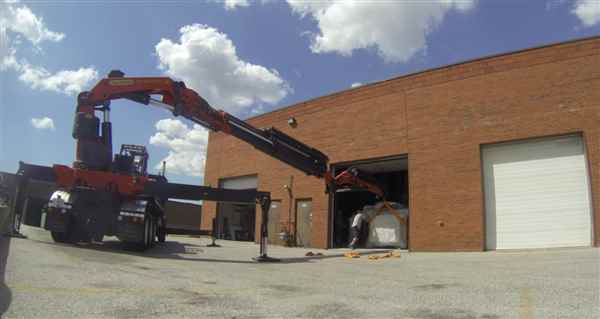 Moving a large piece of machinery into a shop.