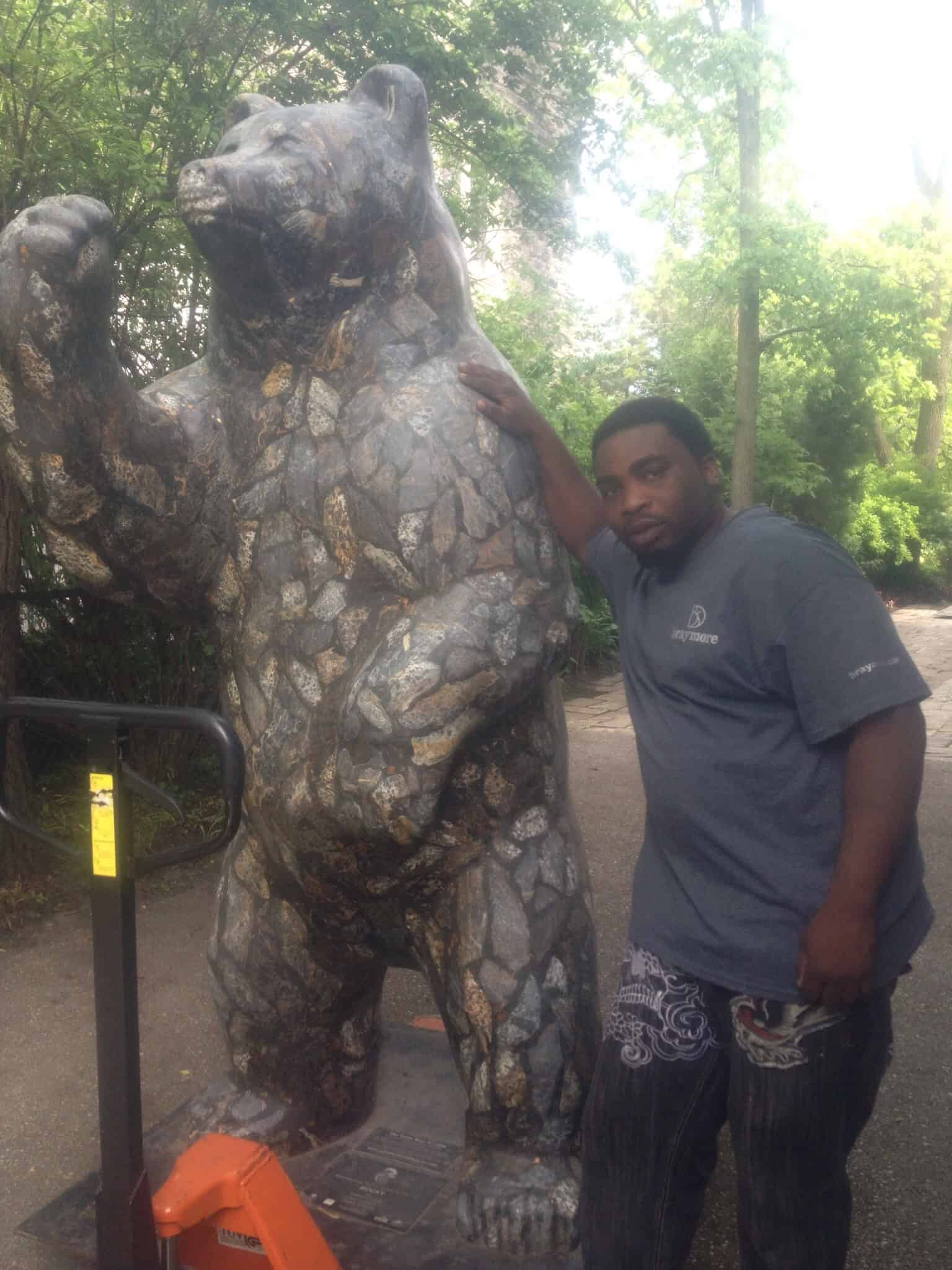 Moving a large bear statue.