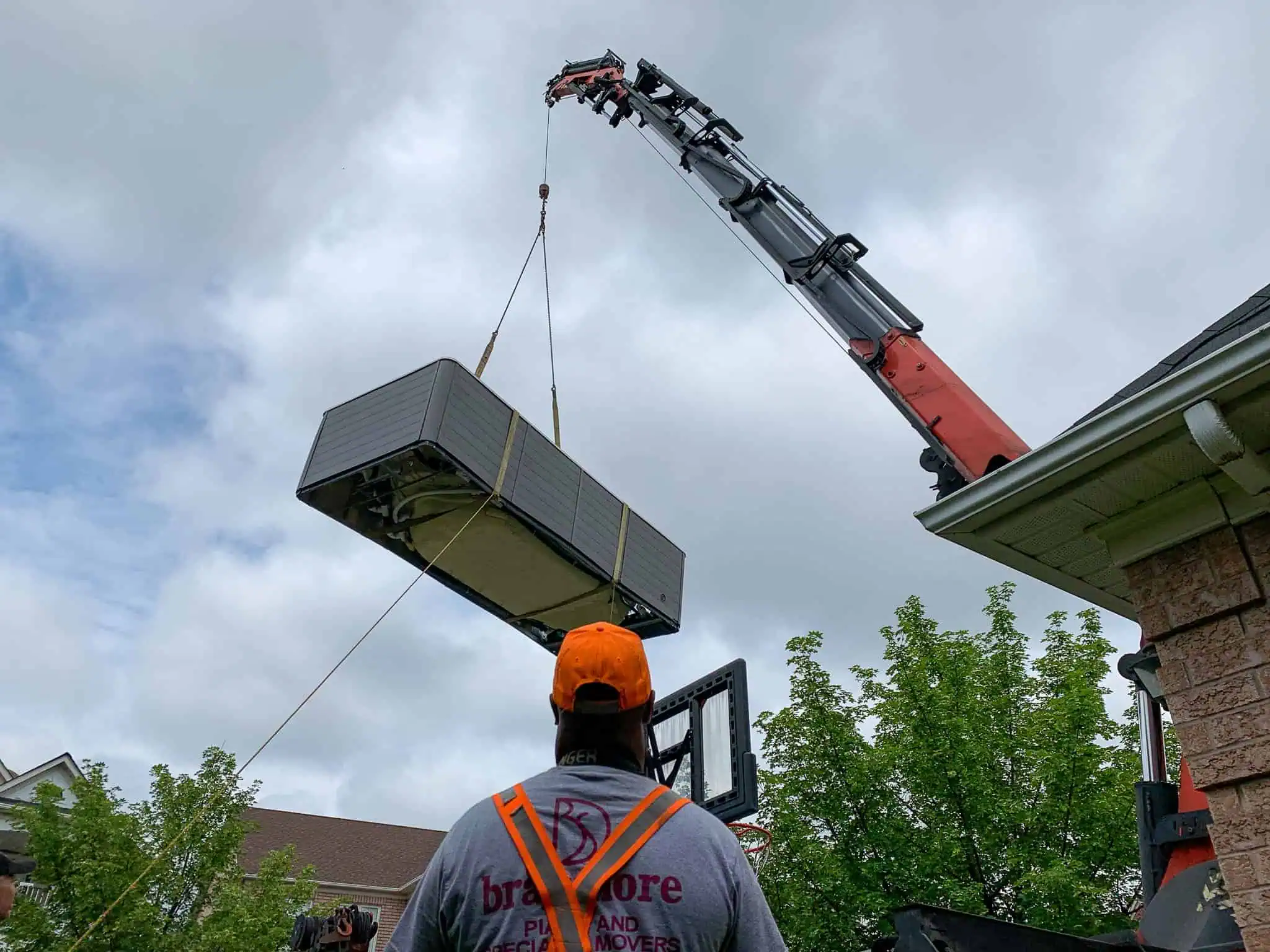 Craning a swim spa over a house and into a backyard