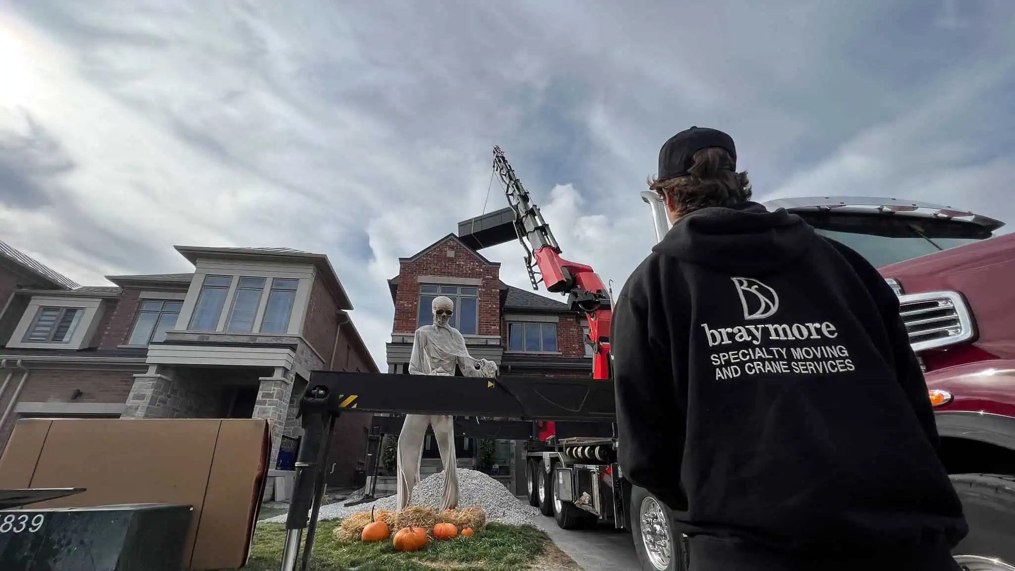 craning a swim spa over a house in Mississuaga at Halloween.