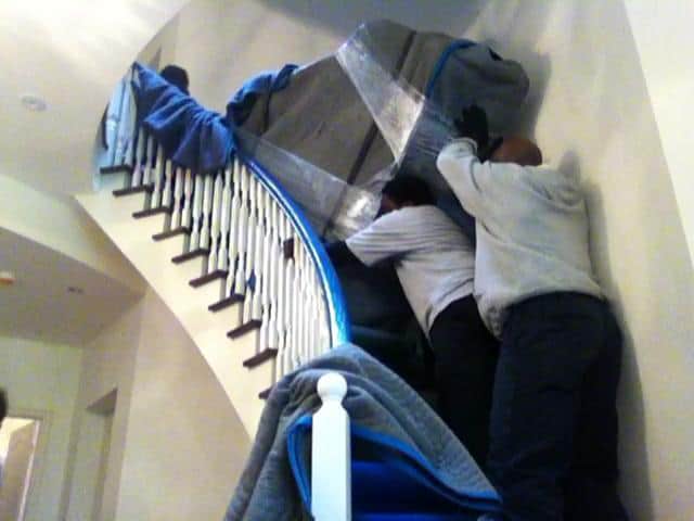 Pushing a grand piano up a spiral staircase