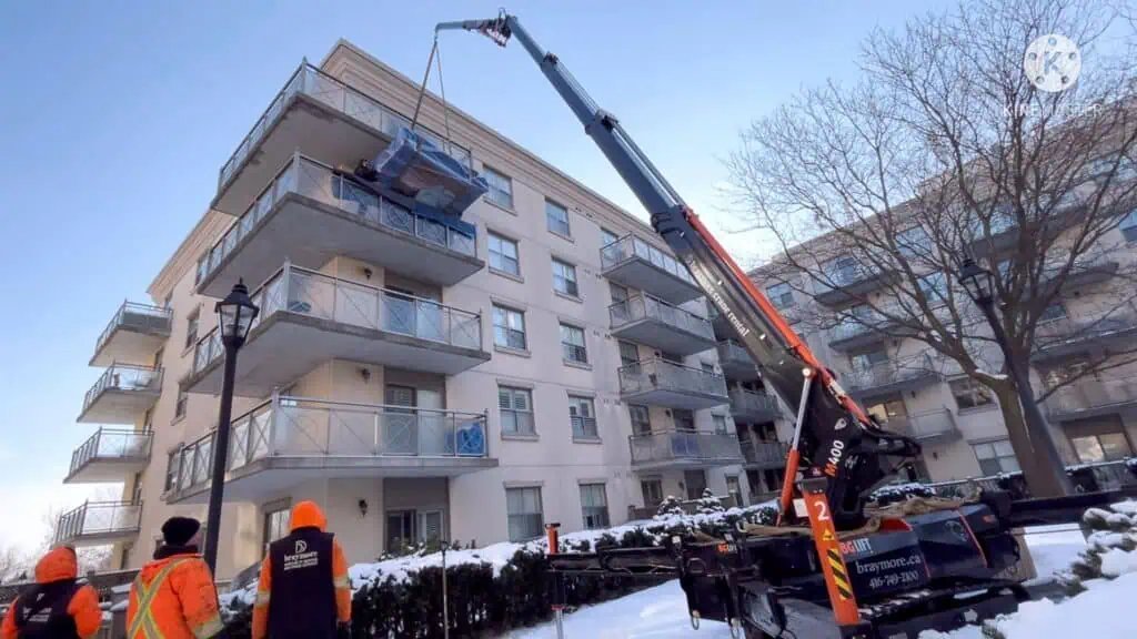 Using a spider crane to lift a china unit 4th floor balcony