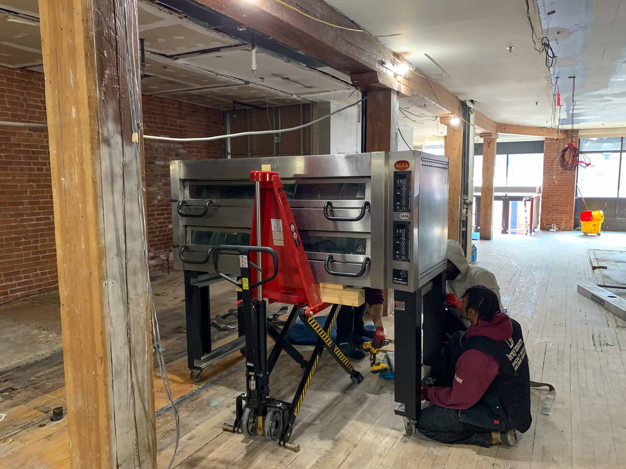 Assembling a pizza oven in a restaurant.