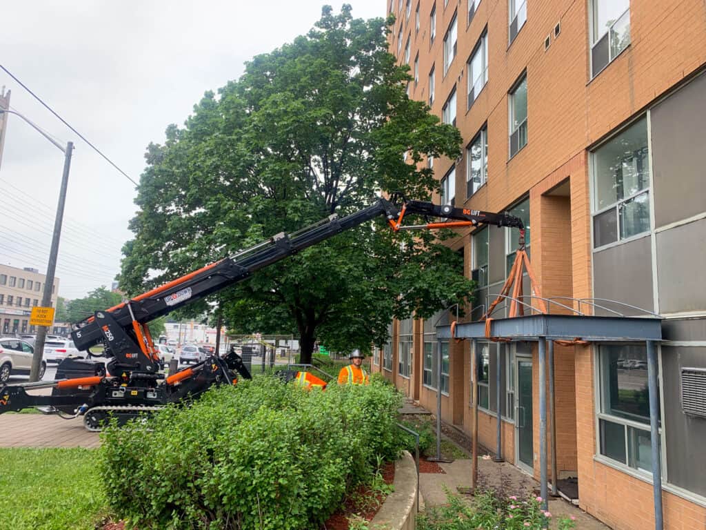 Spider crane lifting & positioning an awning