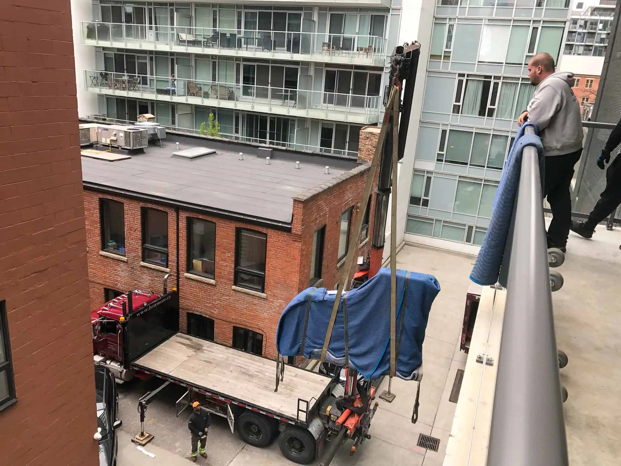 Craning a Bosendorfer concert grand piano onto a condo balcony that would not fit in the elevator.
