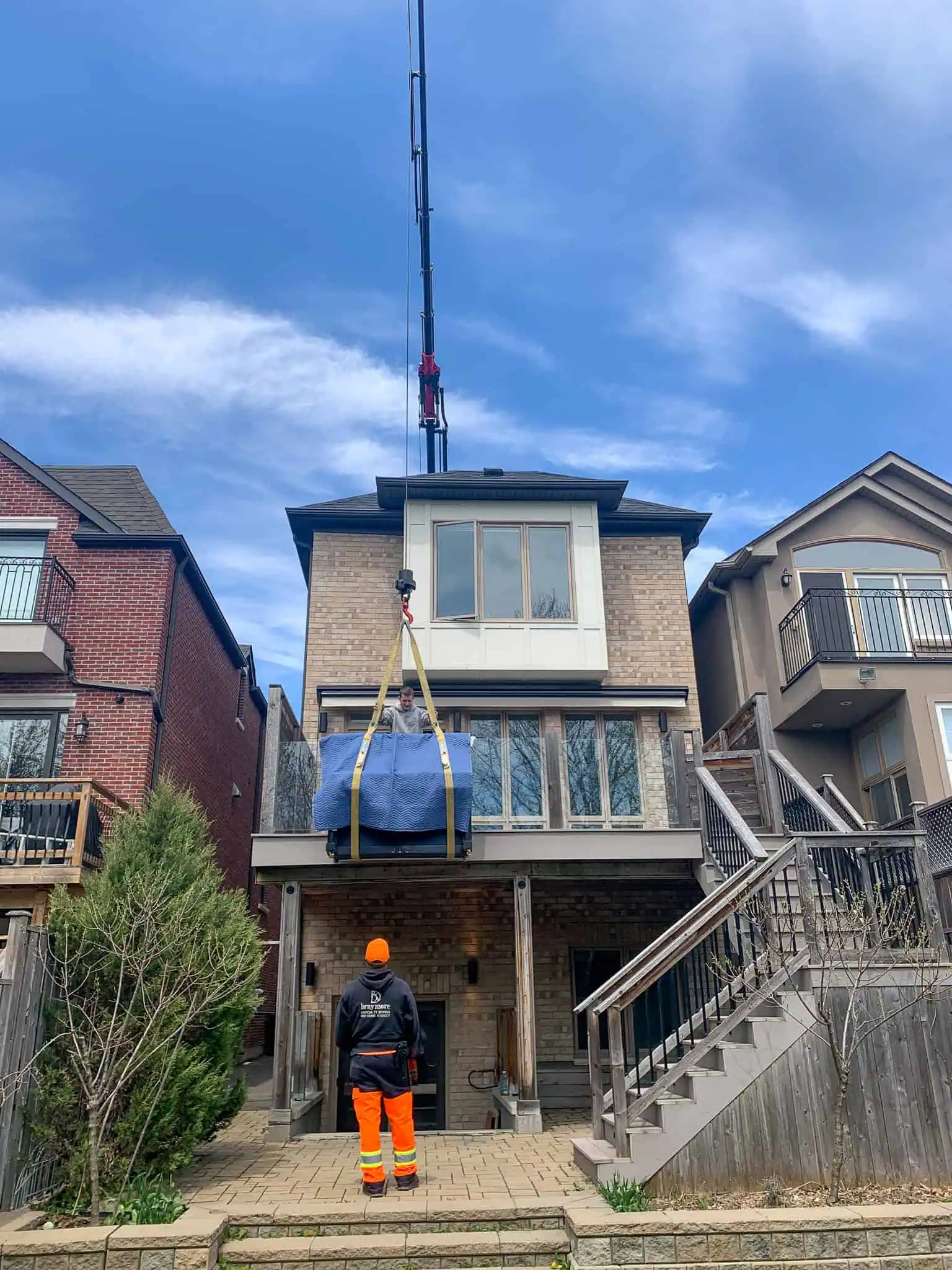 Crane upright piano out of walkout basement backyard.