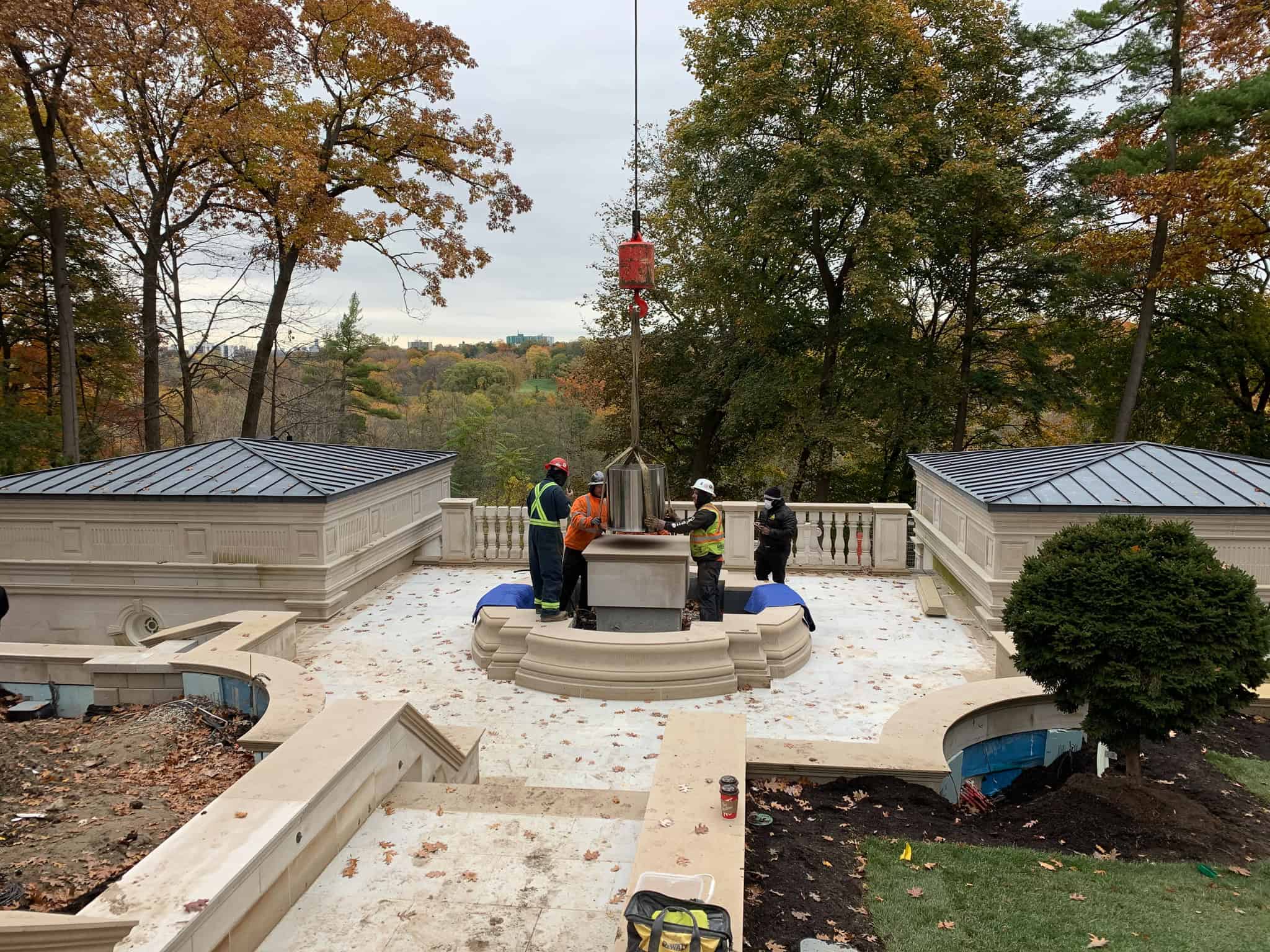 Crane statue base stand into place in a backyard.