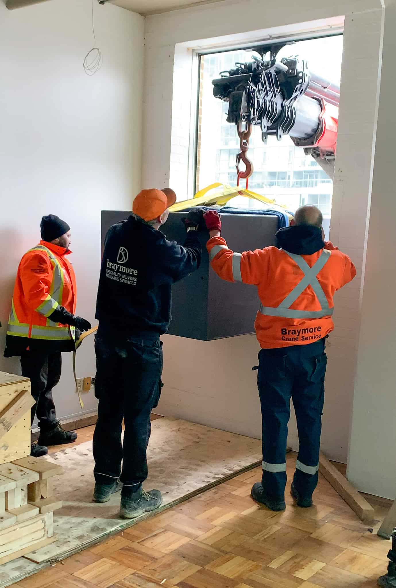 Crane safe through window of building.