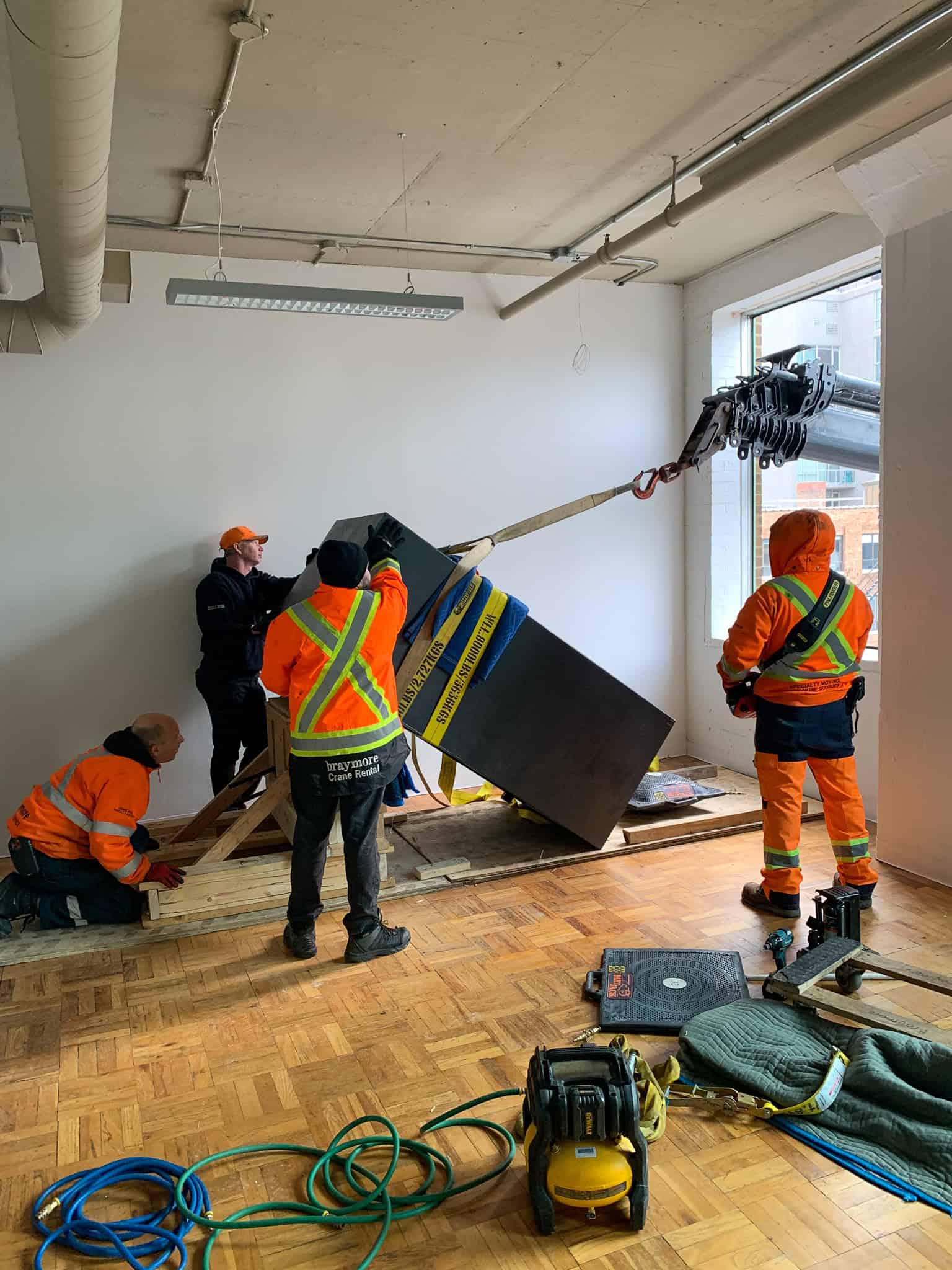 Crane Safe through window of commercial building.