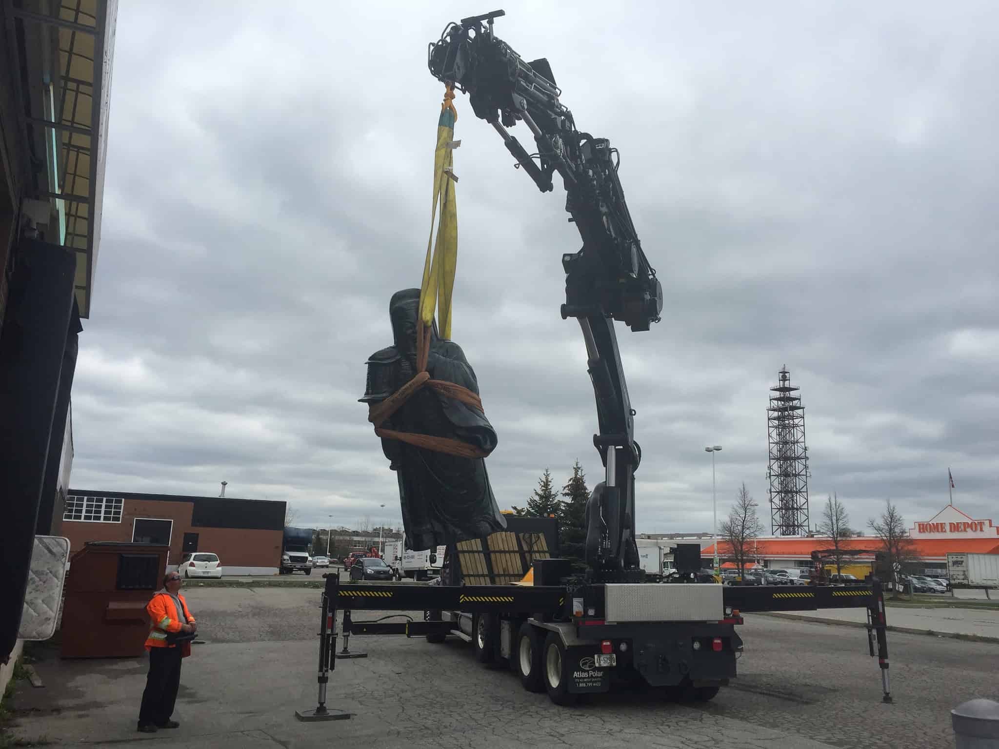 Crane and transport heavy stone statue to customer home.
