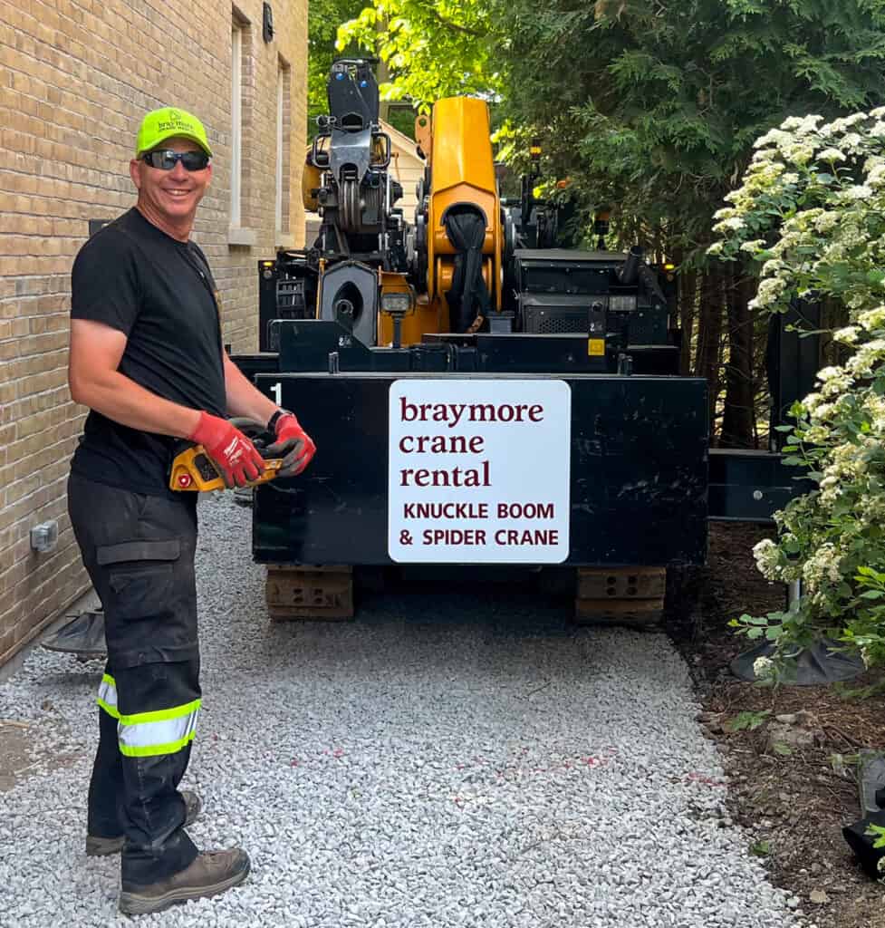 Spider crane driving down a house laneway to get to the backyard.