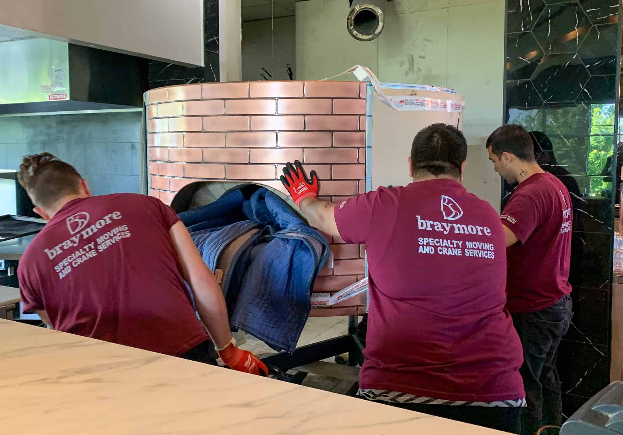 Rolling a new 2700 pound pizza oven into place.