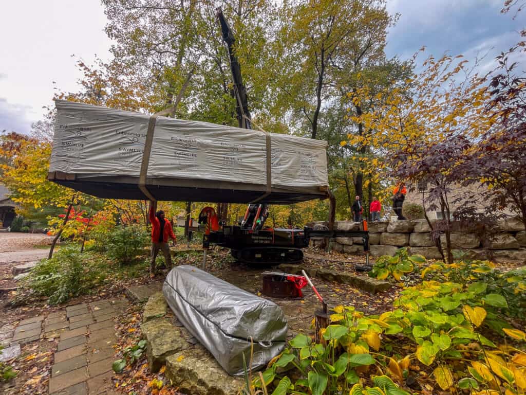 Using a mini crane to carry a 2200 pound swim spa over some rough terrain.