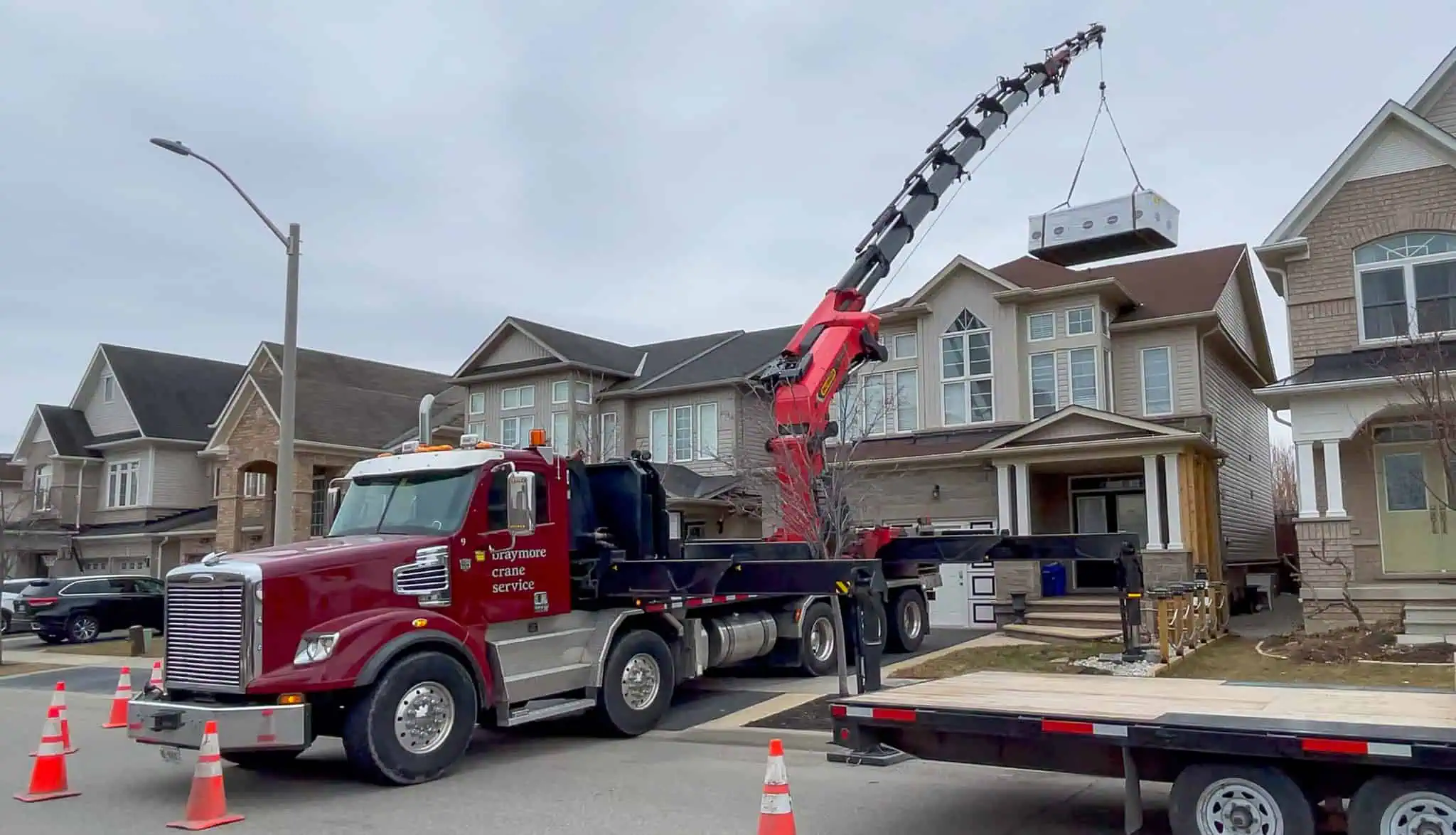 Palfinger 135002 crane swim spa over a house in Burlington.