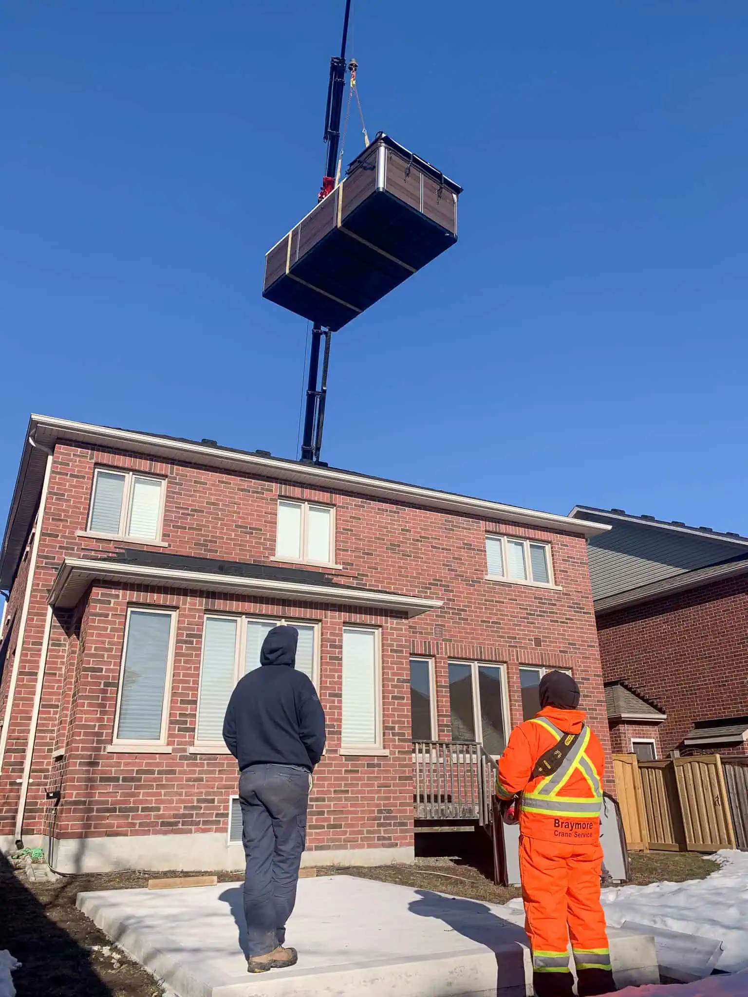 Palfinger 135002 crane swim spa over a house.