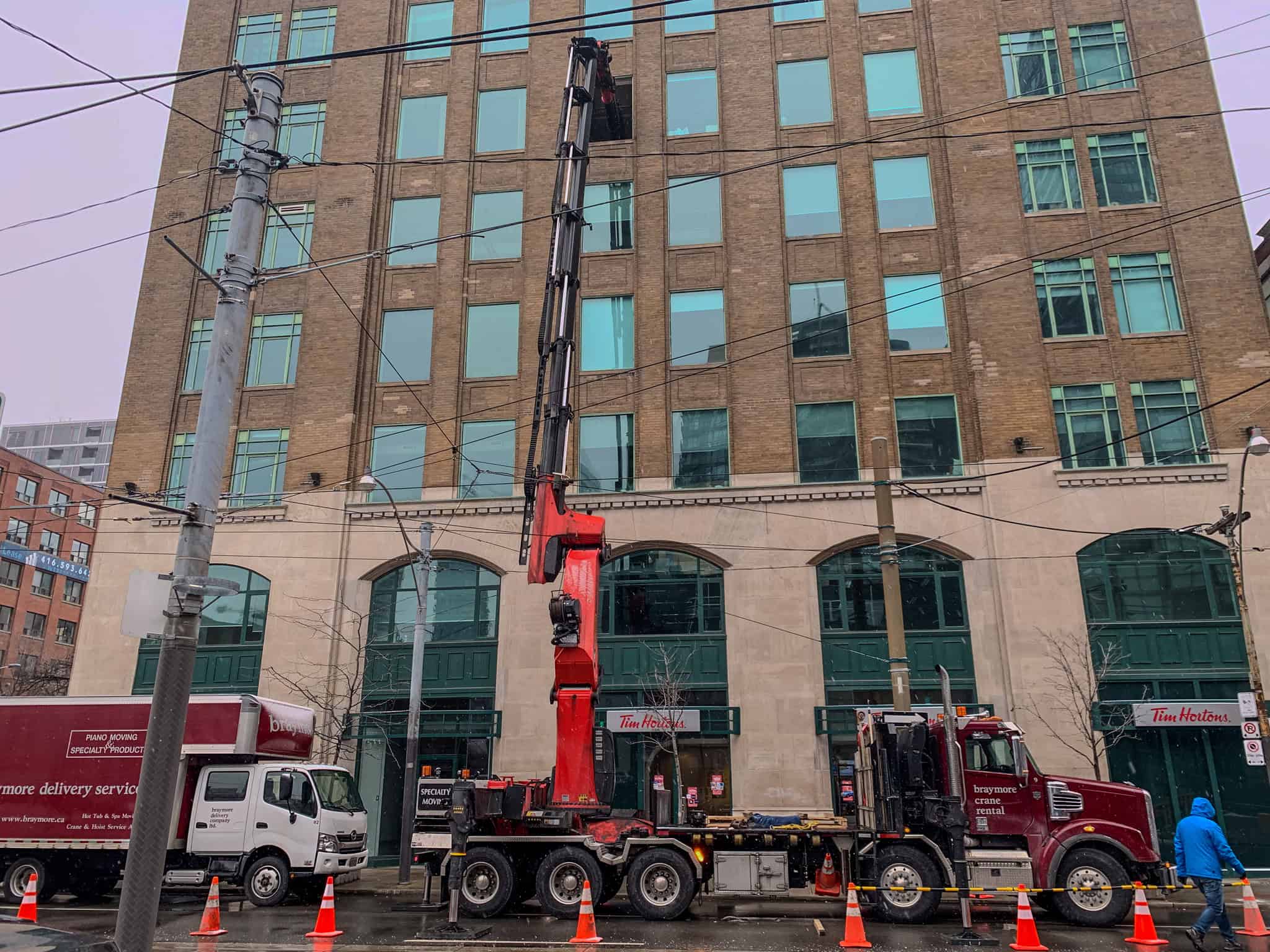 Palfinger 135002 lifting a commercial safe into building through a window.