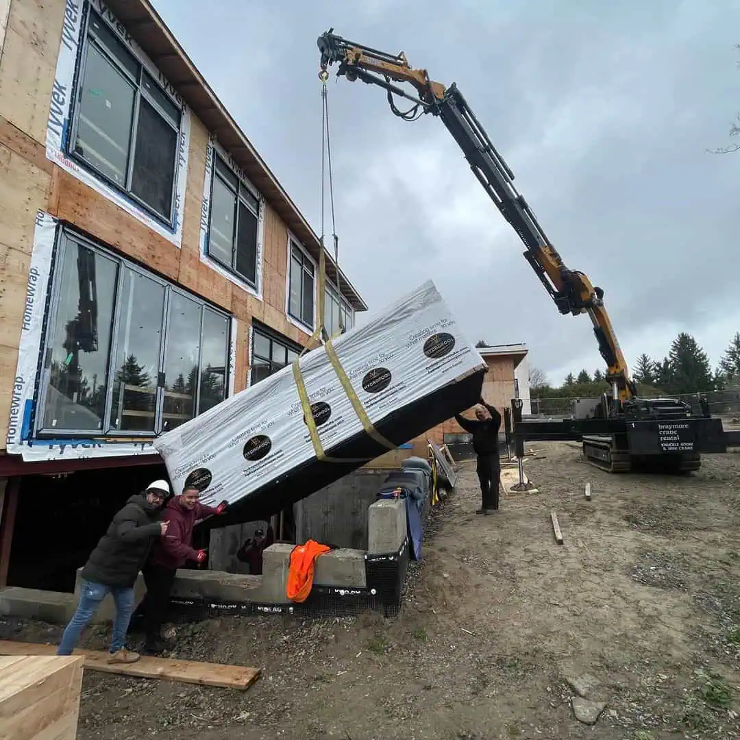 Mini Crane swim spa into basement