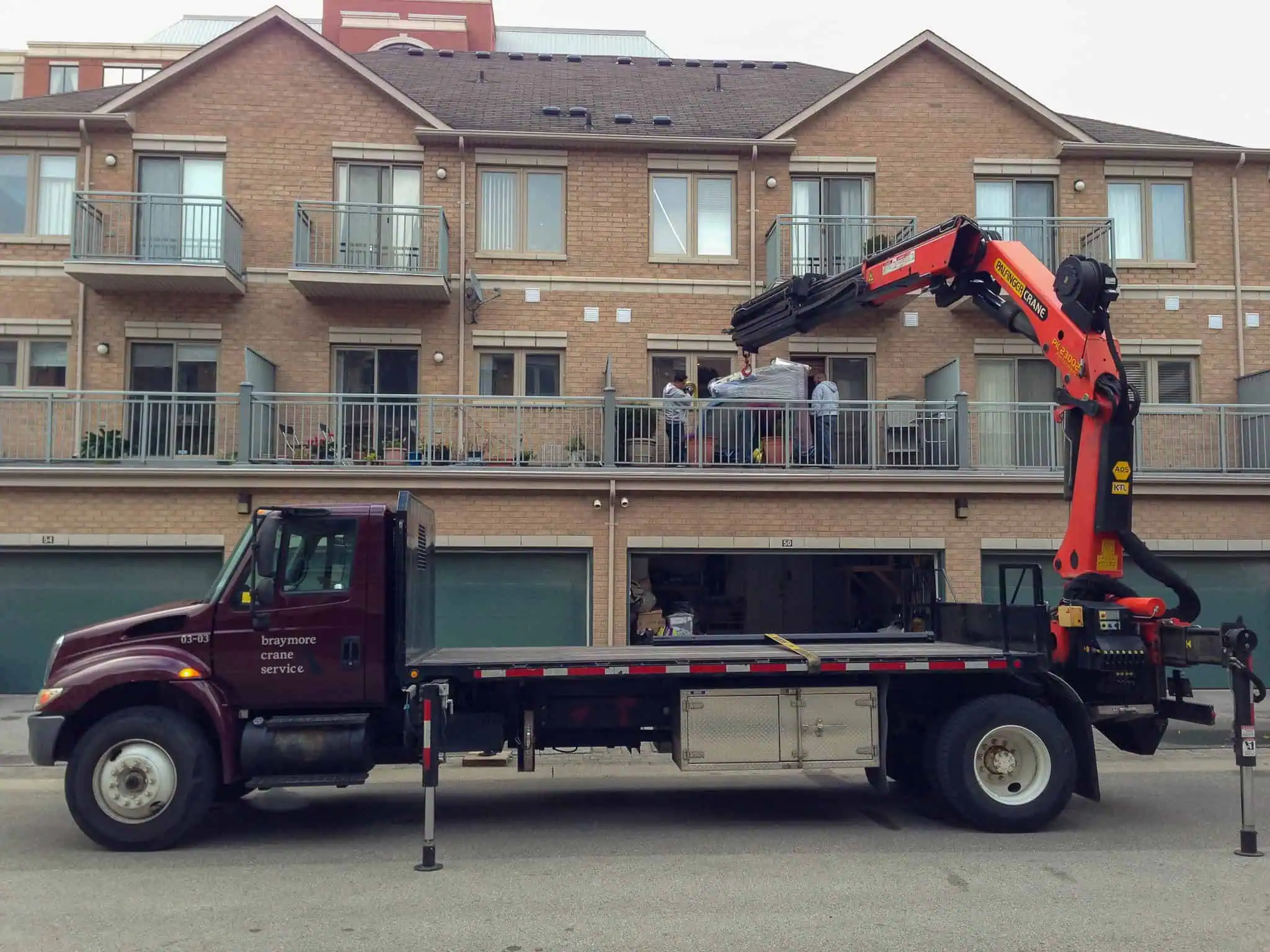 Crane a grand piano onto a second-floor balcony in Markham.