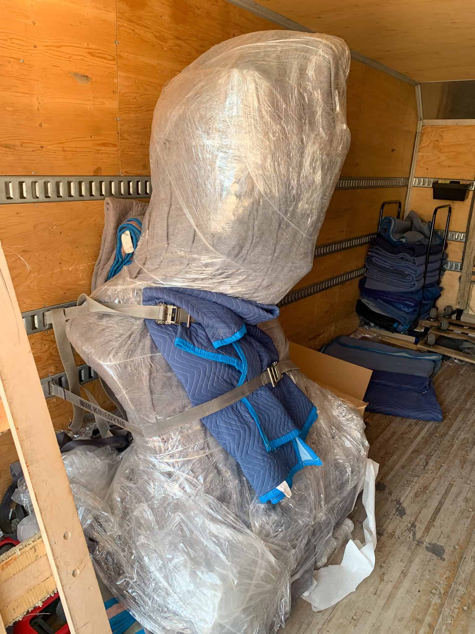 Transporting a statue in a moving truck.
