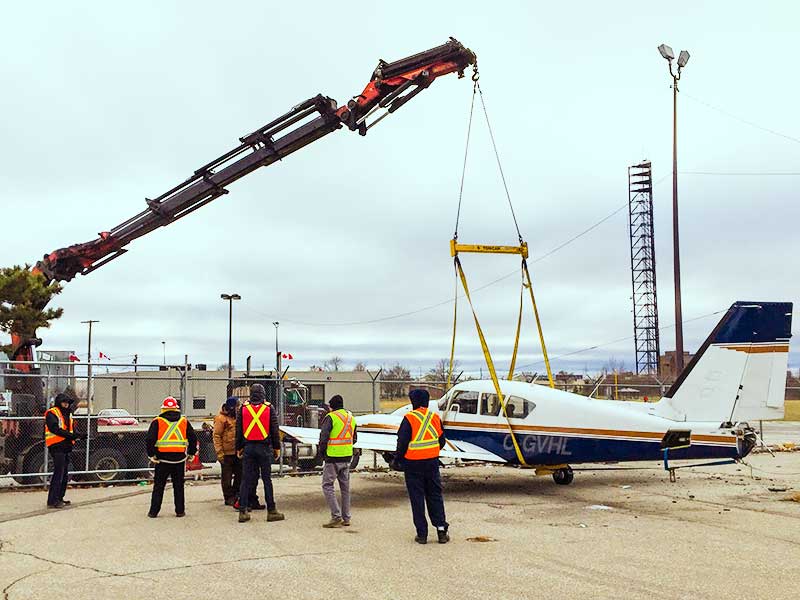 Preparing a small aircraft to be craned in restricted airspace