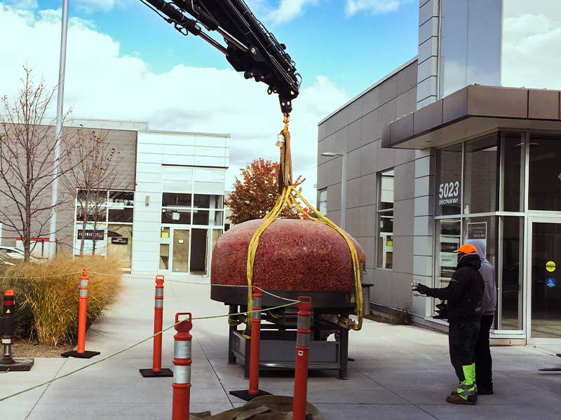 Craning a pizza oven into position