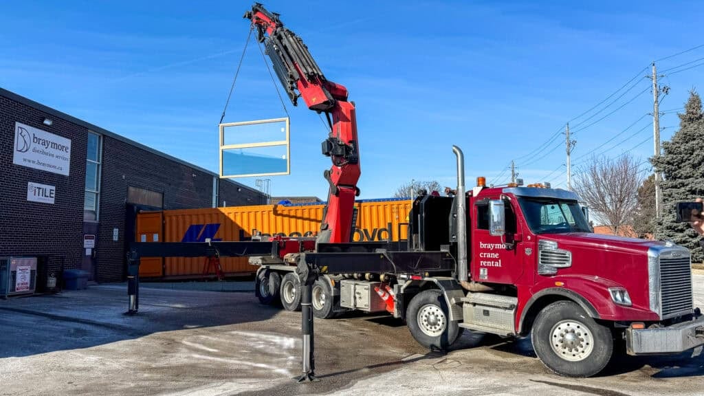 Crane glass window out of open top container.