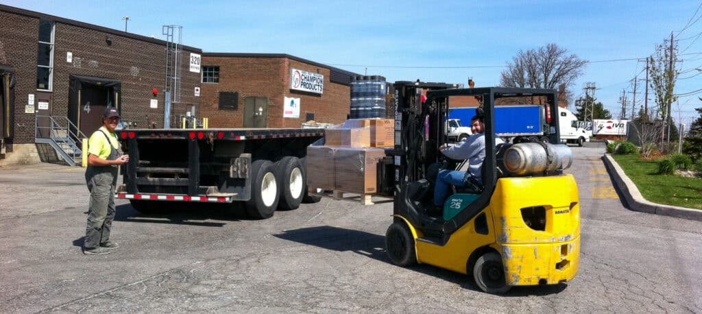 Cross Docking some skids on to a flat bed trailer in Toronto.