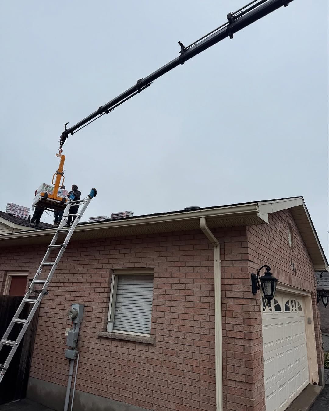 Crane heavy skid onto a roof.