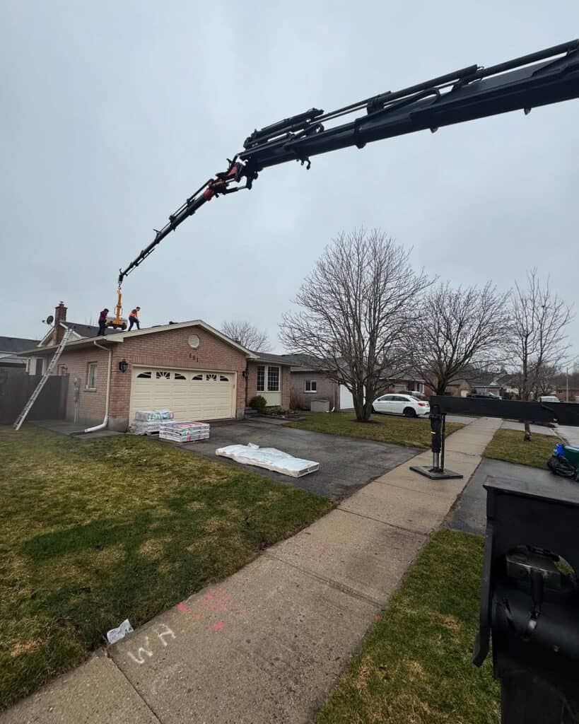 Crane skids onto house