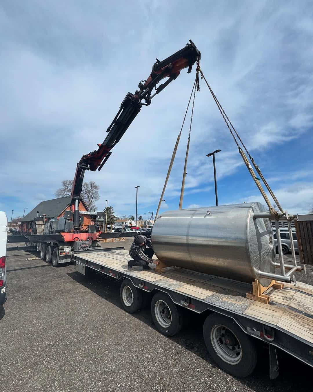Crane silo for brewery onto trailer for transportation.