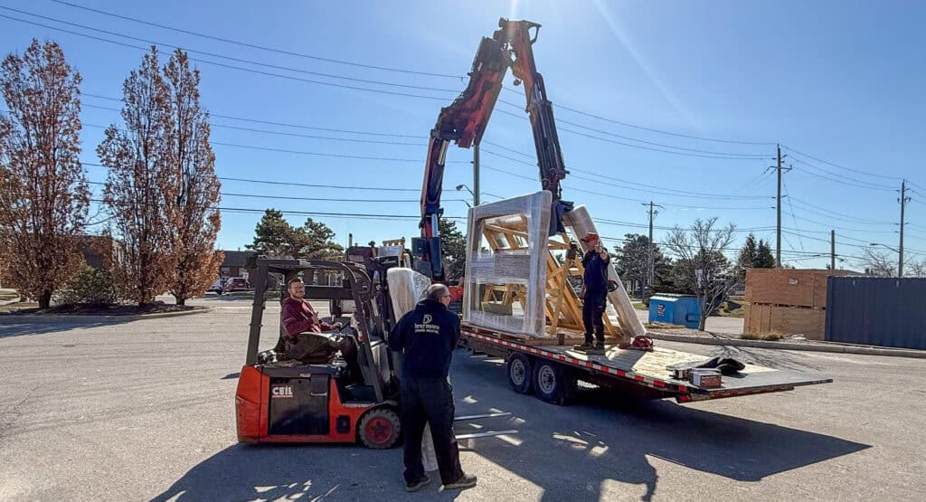 We are using a forklift to load glass onto a trailer.