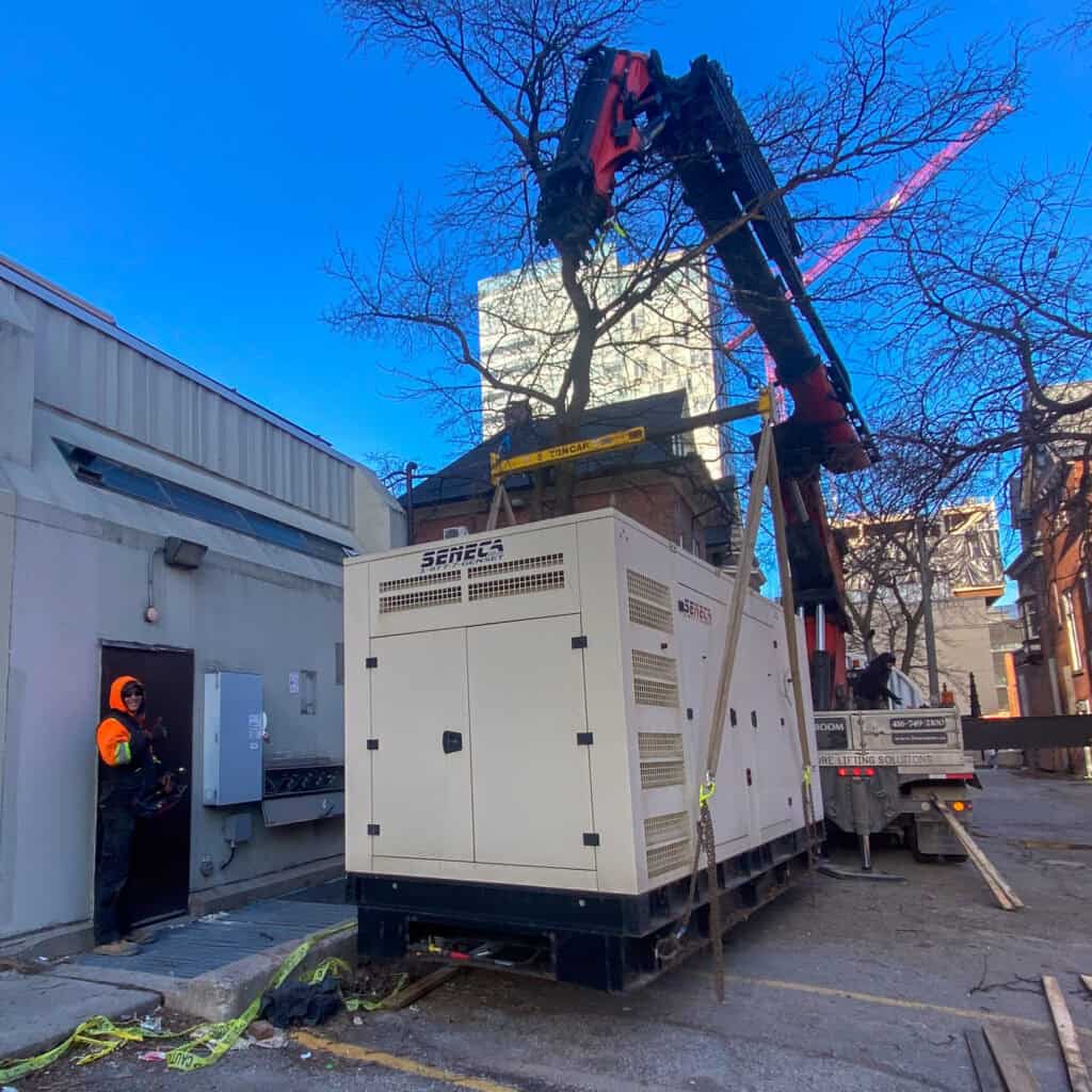 Using a spreader bar on a crane to protect a large generator while it is being lifted.