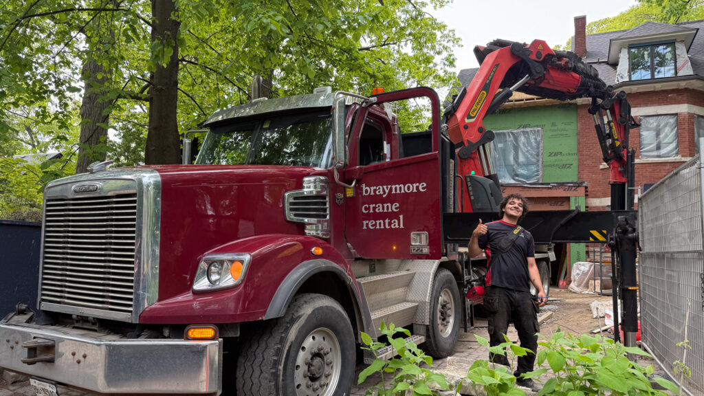 We are using a large knuckle crane to lift items into place on a construction site.