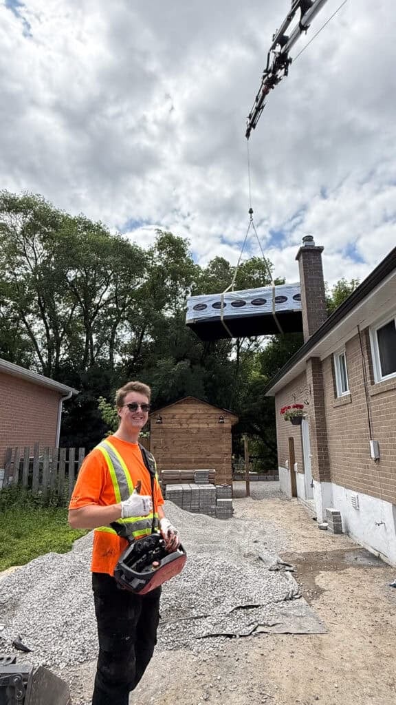 We are using a knuckle crane to lift a 17' swim spa over a house in Newmarket.