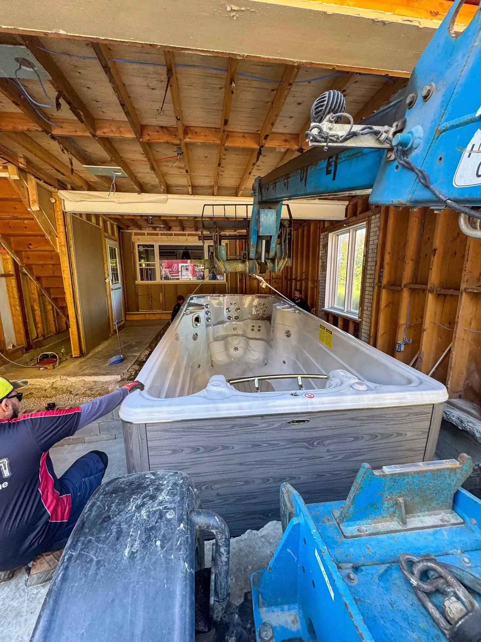 Lowering Swim into garage pit.